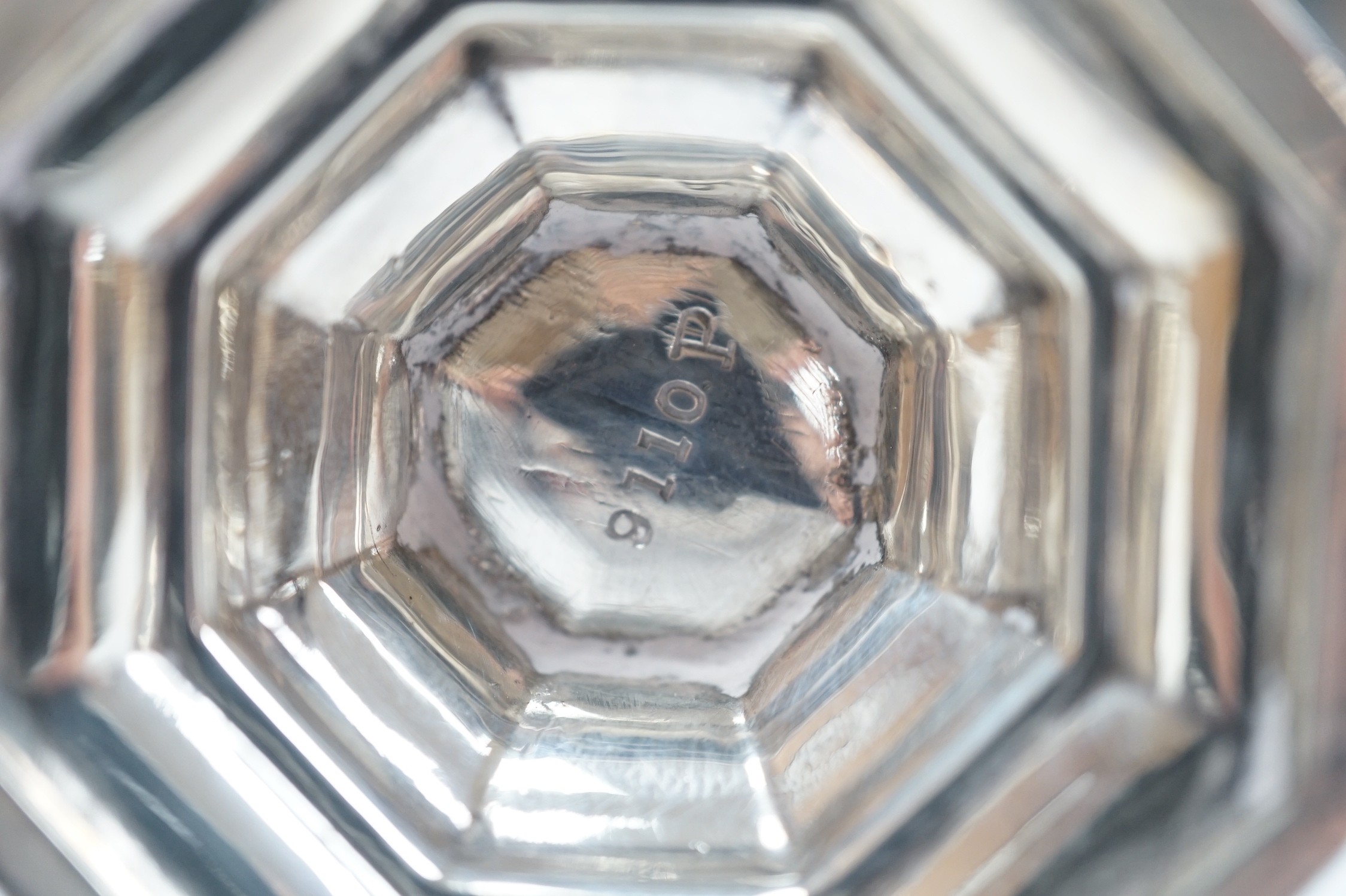 A George V silver octagonal sugar caster, Sheffield, 1910, 15.9cm, a George V silver mounted capstan inkwell and a small silver mustard pot.